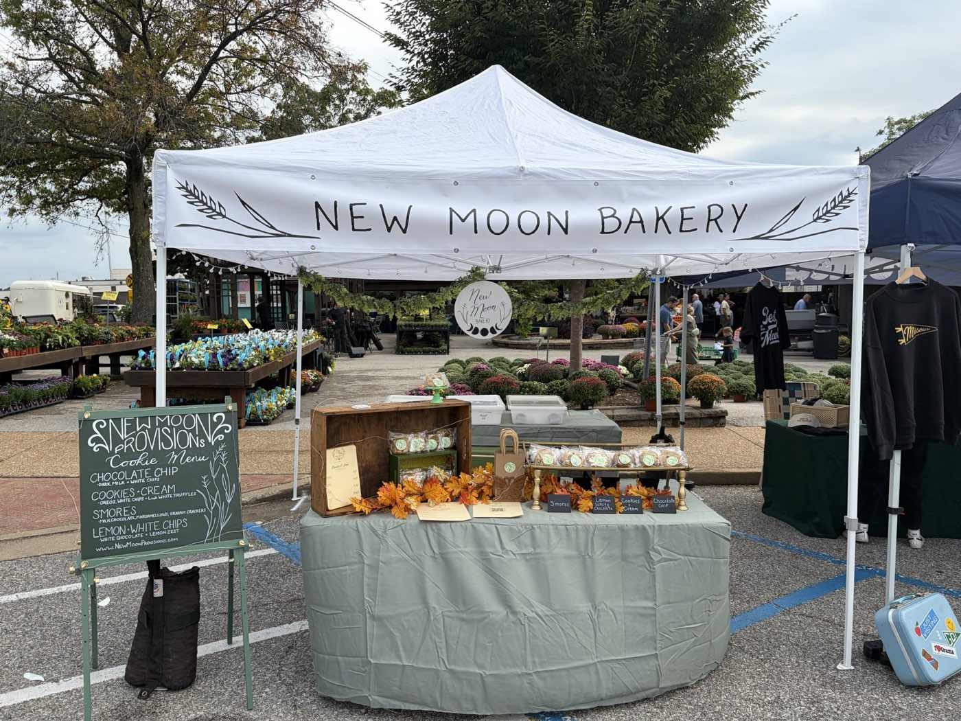 The New Moon Bakery tent with a chalkboard cookie menu at the Night Market on Argonne