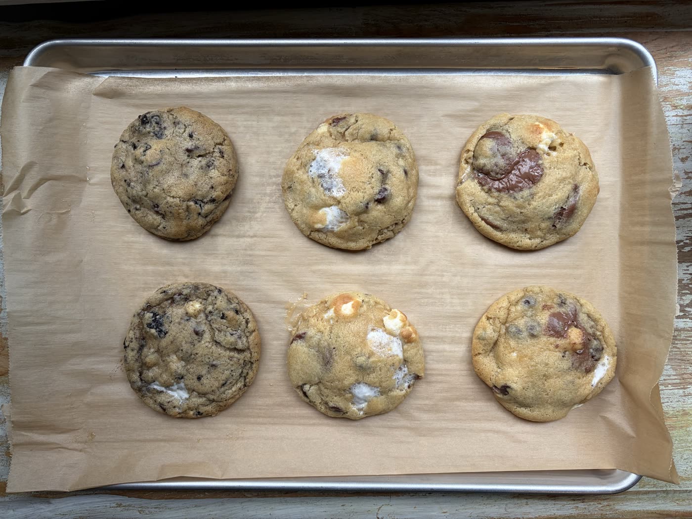 A tray of freshly baked cookies on parchment paper